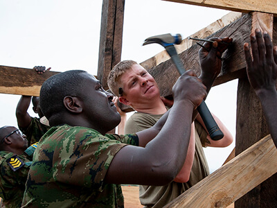 National Guard helping build a structure.