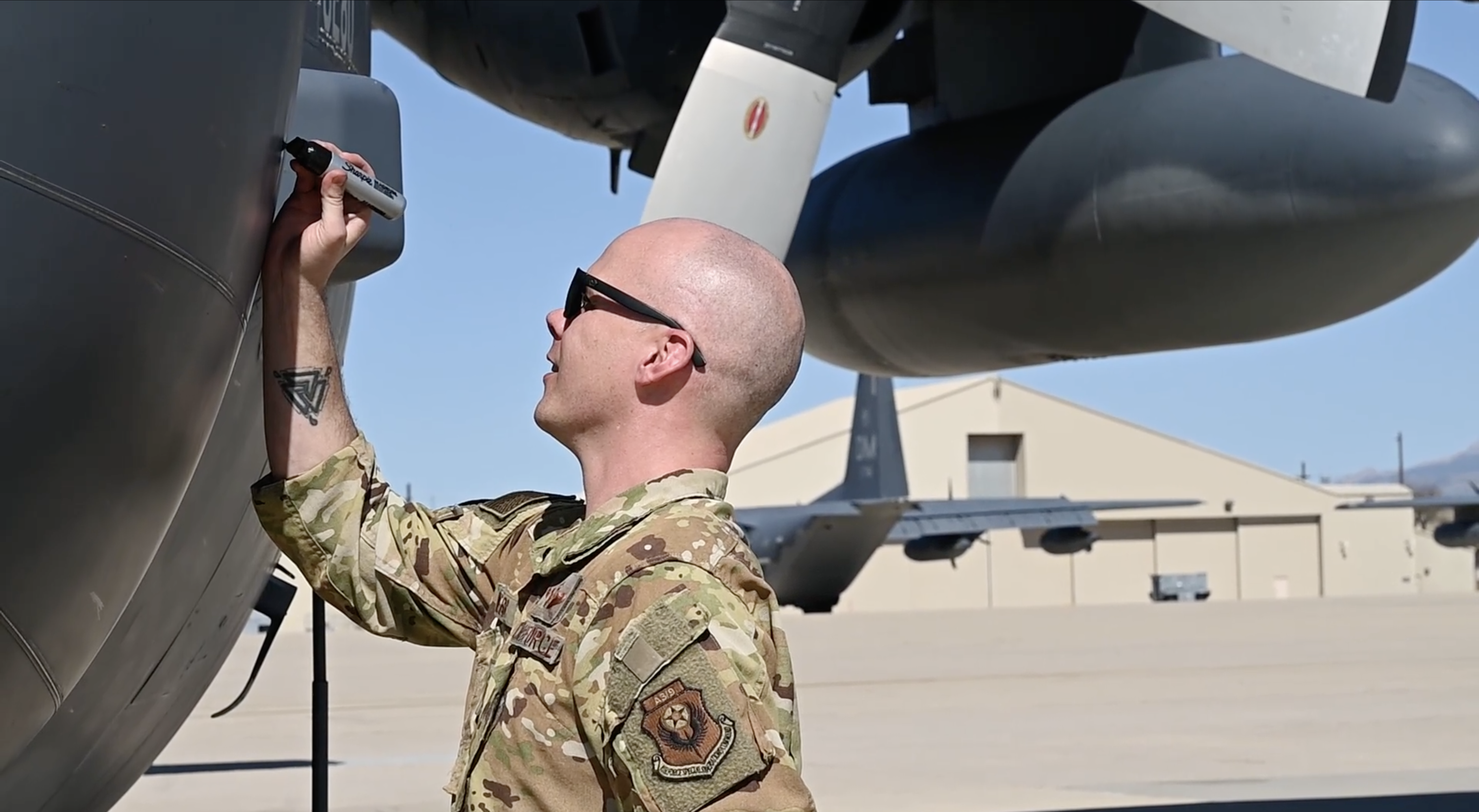 A pilot standing in front of the MC-130H Combat Talon II