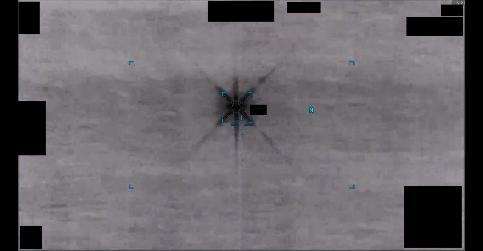 A still image extracted from an infrared video depicting an area of contrast resembling a six-pointed star.