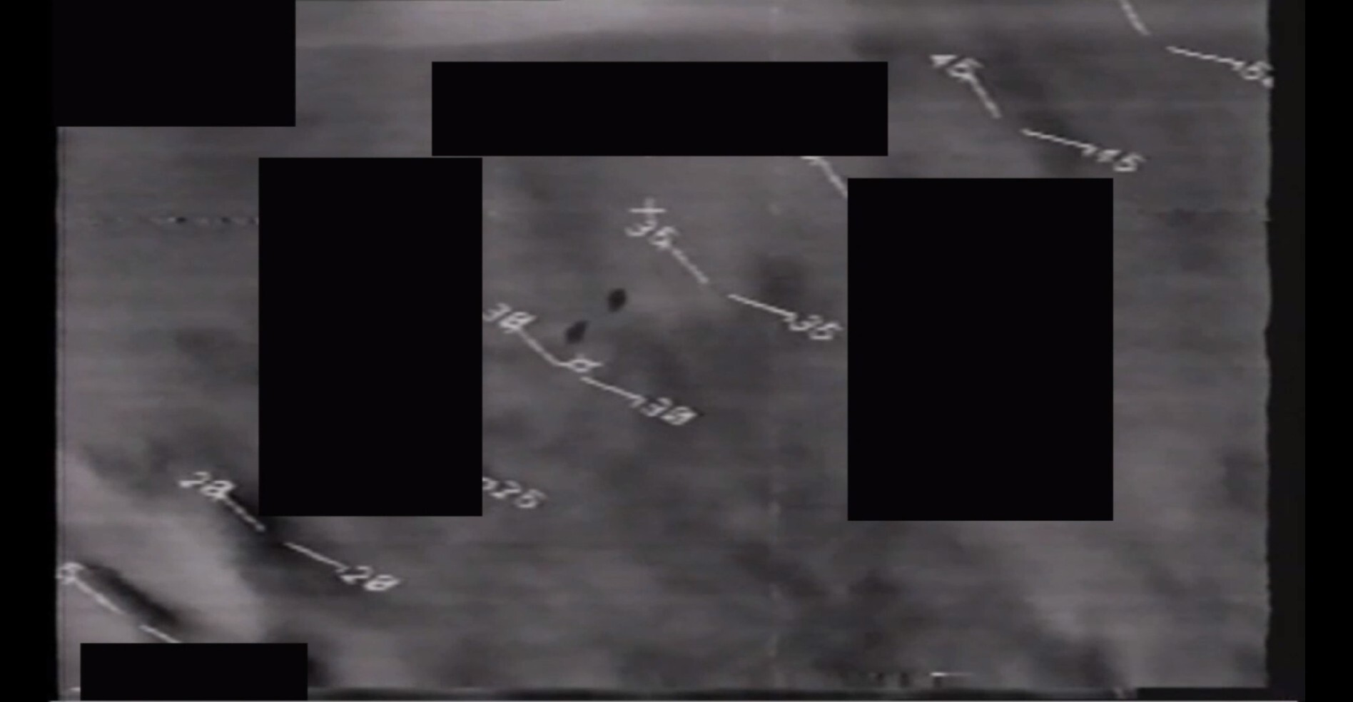 A still image extracted from an infrared video depicting two areas of contrast and certain visual elements of the sensor platform's heads-up display.