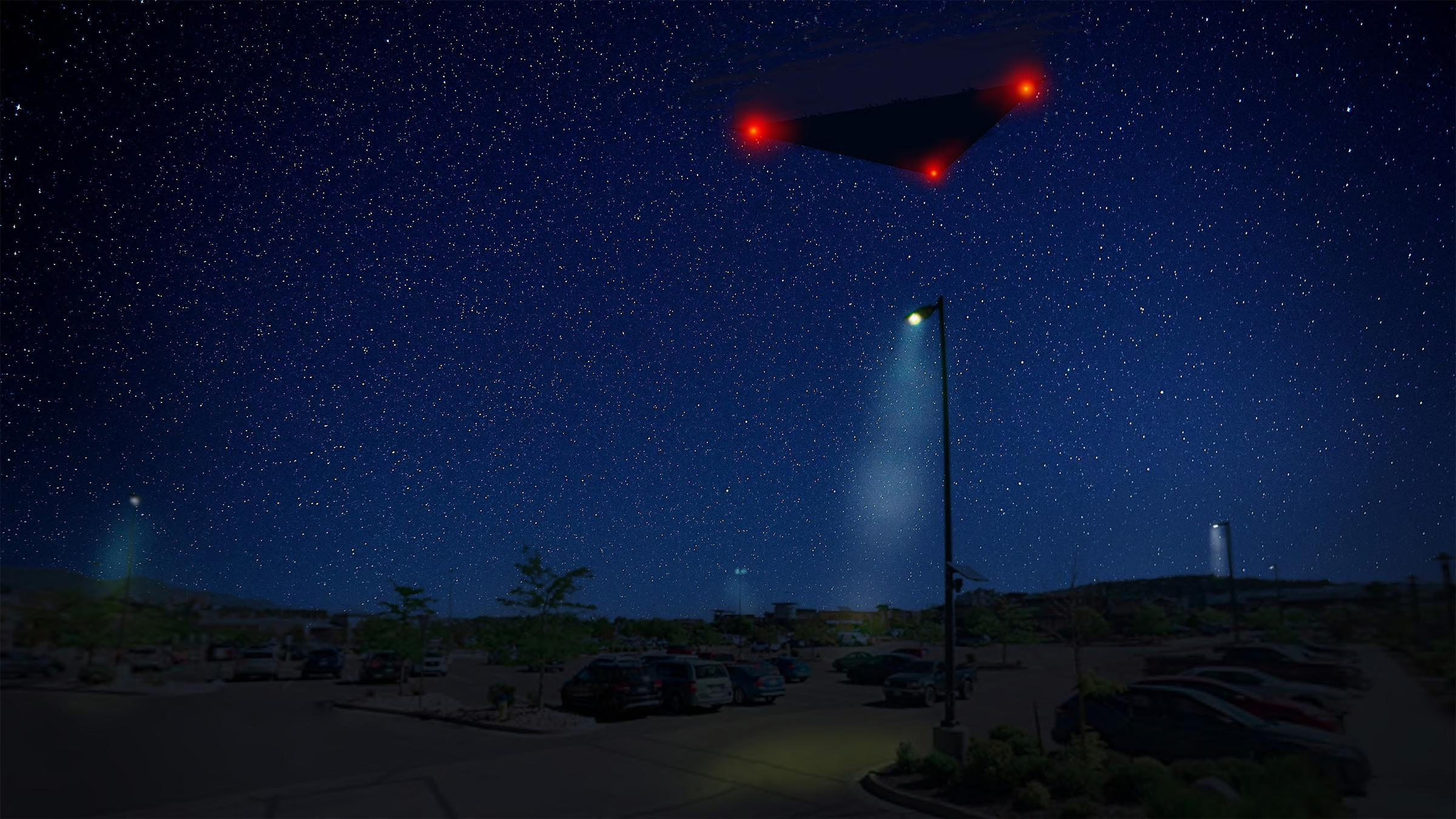 A digital rendering of a large, dark triangular object with red lights flying over a parking lot at night.