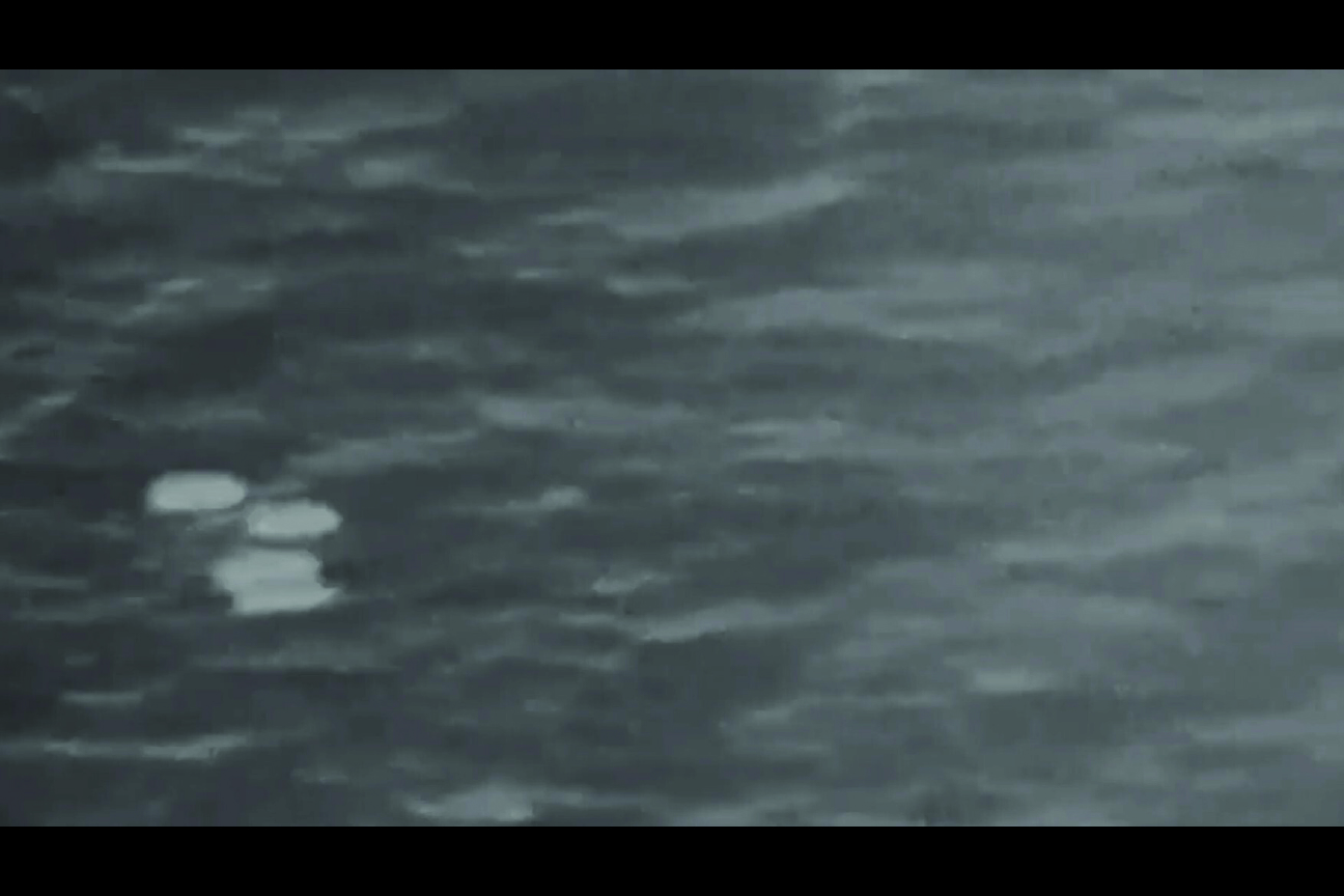 A screenshot from a video likely derived from an infrared sensor, with several areas of contrast near the bottom left of the frame.
