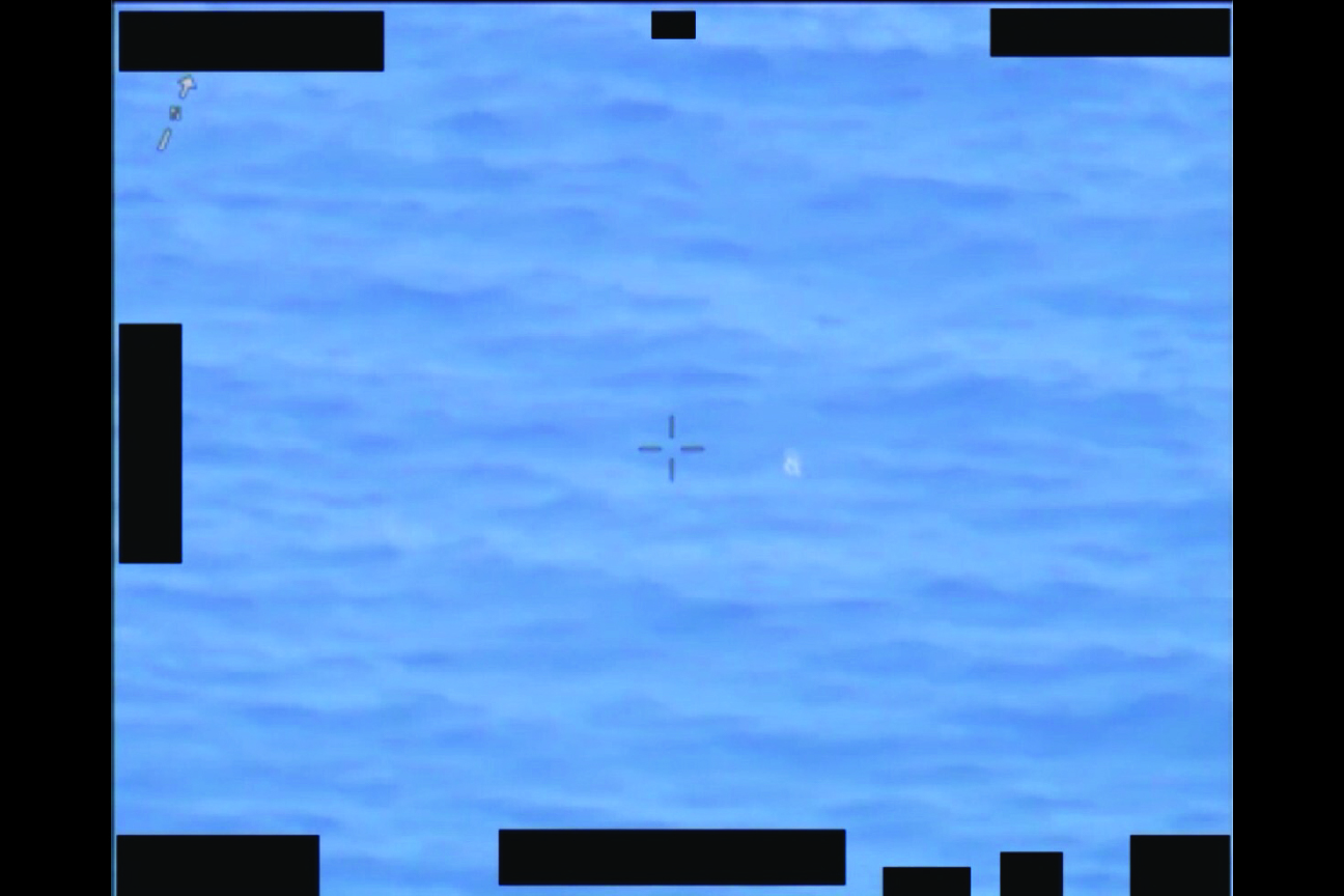 Image of water with a crosshair over an object, with redacted portions.