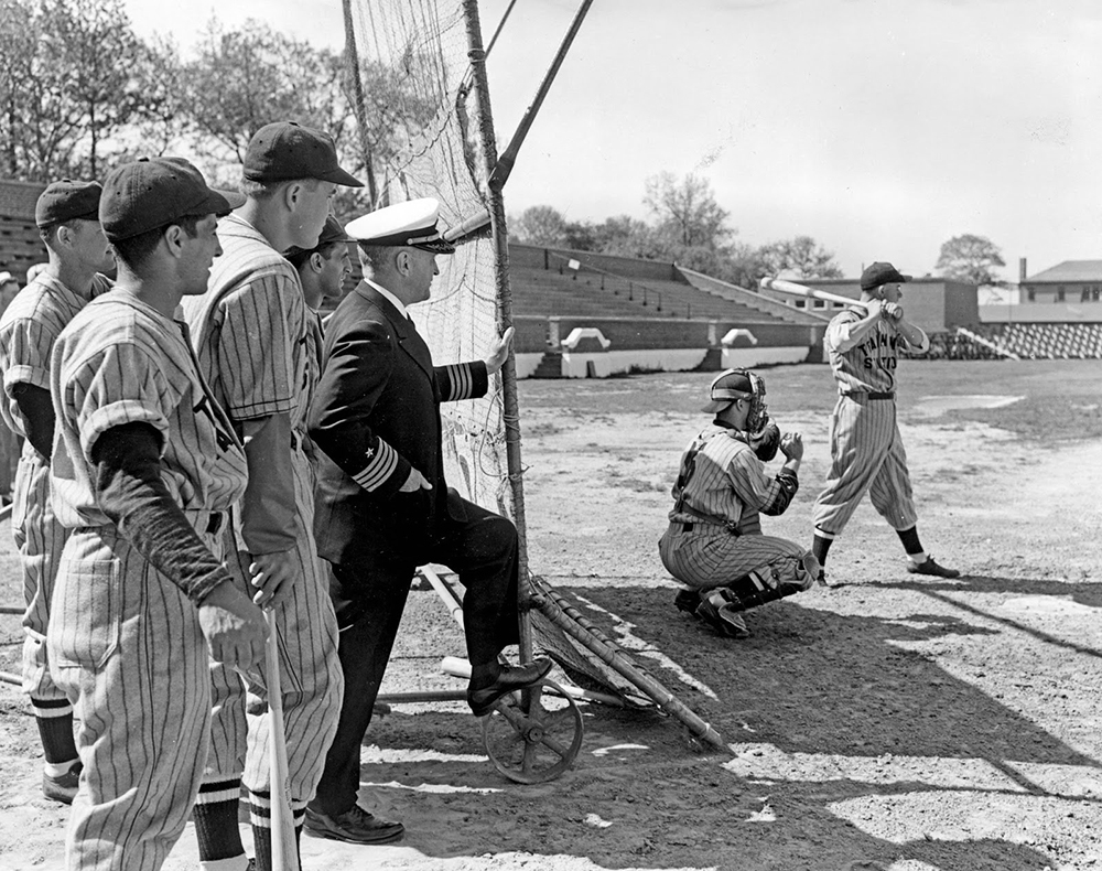 Captain Henry McClure standing with ballplayers.