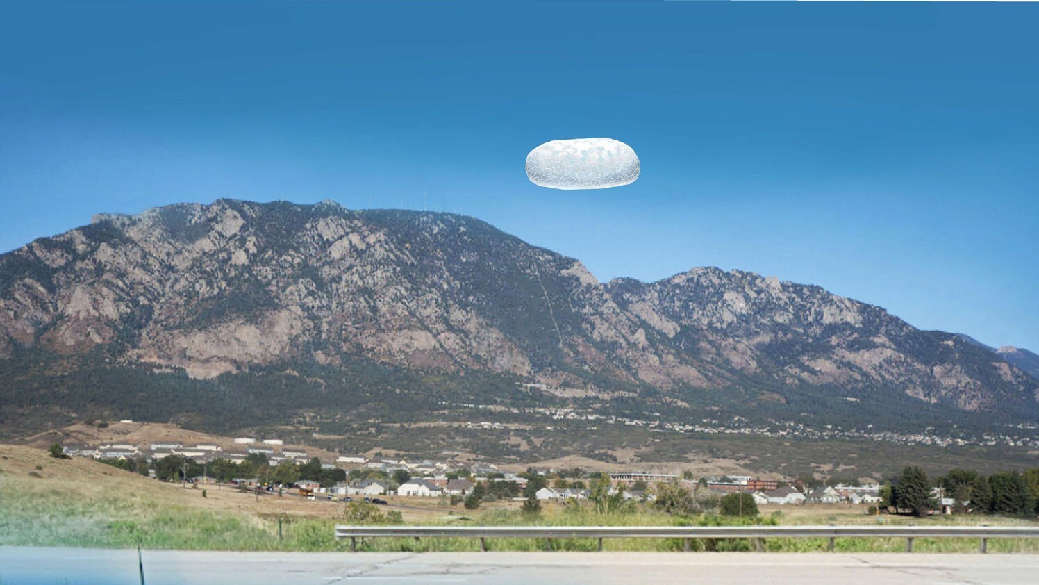 A digital rendering of a phenomenon over a mountain landscape.