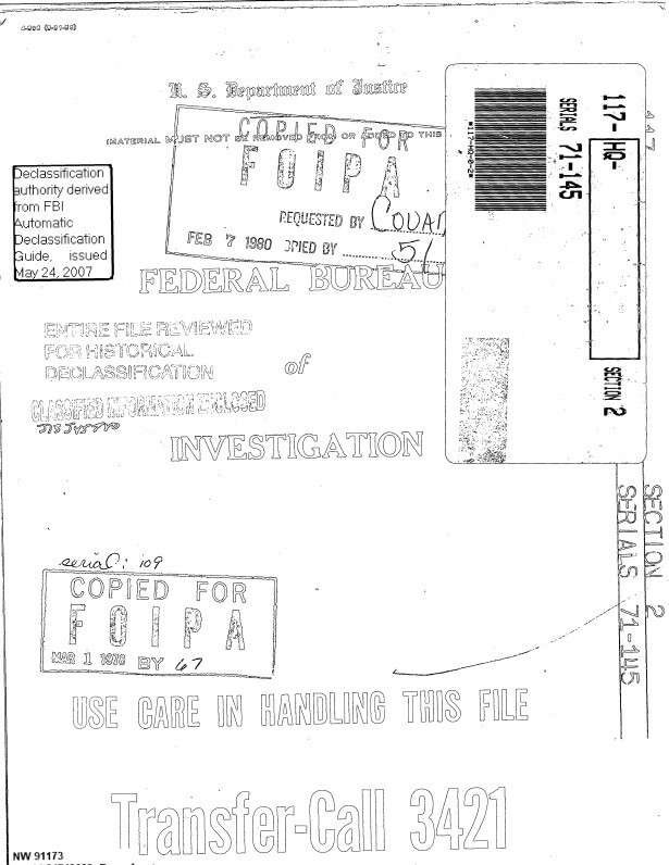 A stamped Department of Justice file cover.